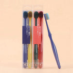 Two packaged pairs of toothbrushes in clear plastic cases beside a single blue toothbrush shown from the side.