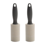 Pair of gray-handled lint rollers standing side by side on white background