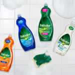 Assortment of Palmolive dish soap bottles and a soapy green sponge arranged on a tiled surface, showing multiple variants