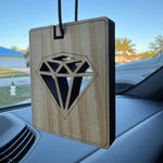 Square wooden hanging air freshener featuring a laser-cut diamond design hanging inside a car