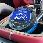 Paradise Platinum Ultimate GEL90 New Car air freshener placed in a vehicle cup holder showing blue gel and label