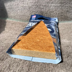 Blue Paradise Air Super Organic New Car pouch opened to show triangular brown fiber scent block resting on fabric