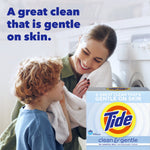 Smiling parent and child by a washer with a Tide Clean & Gentle box pictured and headline about a gentle clean