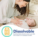 Smiling parent leaning over a baby with graphic text and icon reading "Dissolvable" about soothing tablets.