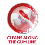 Illustration of toothbrush head cleaning along the gum line with bristles reaching between teeth inside circular frame