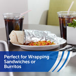 Plate with a partially wrapped burrito in foil next to drinks, staged to show foil used for wrapping sandwiches or burritos