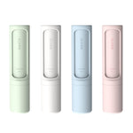 four pastel handheld lint removers standing upright in green, white, blue, and pink