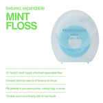 Clear compact Pearlyfloss spool showing blue floss alongside text highlighting textured expandable mint floss features