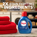 Persil Original detergent bottle on a laundry counter next to folded red towels with headline text about 2x stain fighting ingredients
