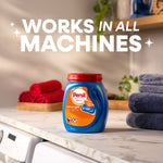 Persil Ultra Pacs tub staged on a laundry counter with folded towels and 'Works in all machines' text