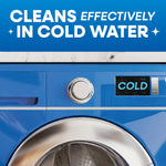 Close-up of a blue front-load washing machine control panel and door with text ‘Cleans effectively in cold water’