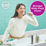 Person brushing teeth in a tiled bathroom with Tom’s of Maine branding and a circular callout saying stronger minty fresh flavor.