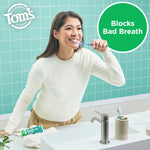 Smiling person brushing teeth at a sink with Tom's of Maine Wicked Fresh toothpaste visible and a green callout 'Blocks Bad Breath'.