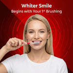 Smiling woman brushing with a Colgate 360 toothbrush against a red branded background reading ‘Whiter Smile Begins with Your 1st Brushing’