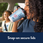 Person drinking from a Chinet Comfort patriotic patterned paper cup with snap-on lid in car scene