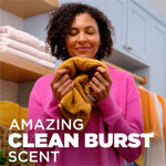 Lifestyle image of a person smelling a towel with overlaid text reading amazing clean burst scent