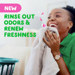 Smiling person smelling a towel with overlay text promoting rinse out odors and renew freshness
