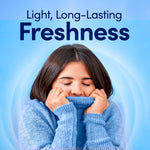 Person smelling a soft blue sweater with 'Light, Long-Lasting Freshness' headline and Downy Light branding