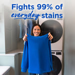 Smiling person holding up a bright blue sweatshirt in a laundry room with 'Fights 99% of everyday stains' headline