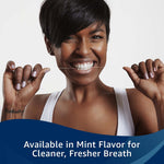 Smiling person holding a strand of dental floss taut between both hands in a lifestyle image promoting flossing.