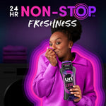 Person in purple sweater holding a Downy Unstopables Lush bottle, smiling and inhaling fabric near bold 'NON-STOP Freshness' text