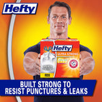 Muscular person holding a Hefty Ultra Strong box against an orange background with text about resisting punctures and leaks