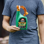 Person holding Ortho WeedClear ready-to-spray bottle with visible front label and orange handle