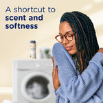 Person hugging a sweater with a washing machine and a Downy Blends bottle in the background and text about scent and softness
