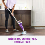 Person using a Rejuvenate mop in a kitchen setting on a dark floor with text 'Dries Fast, Streak-Free, Residue-Free'