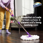 Person mopping a dark wood floor with purple mop head and Fabuloso logo and text