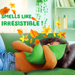 Person resting on a green couch hugging a green pillow with orange floral scent graphics and text ‘Smells like irresistible!’