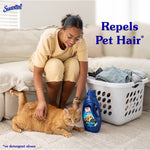 Person kneeling and petting an orange cat next to a laundry basket and a Suavitel Shed Shield bottle with text 'Repels Pet Hair'