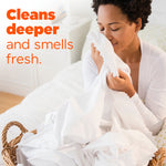 Person holding and smelling a white sheet from a laundry basket with overlaid text 'Cleans deeper and smells fresh.'