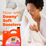 Smiling person smelling a white sheet with a small image of an orange Tide+Downy detergent bottle and copy promoting Downy Soft Boosters.
