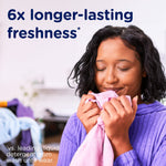 Person smelling a pink towel with on-image text claiming "6x longer-lasting freshness" beside them.