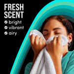 Person smelling a white towel beside teal graphic arcs and text describing a ‘Fresh Scent’