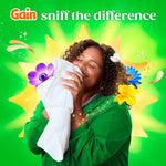 Person smelling a white towel with a happy expression surrounded by floral graphics and ‘sniff the difference’ text