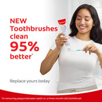Smiling person holding a Colgate tube and brushing a Colgate toothbrush with text claiming new toothbrushes clean 95% better