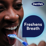 Lifestyle-style close crop of person using a blue DenTek Orabrush on their tongue with ‘Freshens Breath’ callout