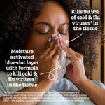 Person pressing a tissue to their nose with overlay text describing Kleenex Anti‑Viral kills 99.9% of cold & flu viruses and moisture‑activated blue‑dot layer.