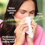 Person holding a Kleenex tissue to their nose with overlays pointing to 'Hint of aloe' and hydration benefit