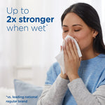 Person holding tissues to their face with copy stating ‘Up to 2x stronger when wet’ against a soft indoor background