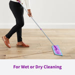 Person using a purple Rejuvenate mop on a wood floor demonstrating wet or dry cleaning motion.
