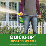 Lifestyle image of person holding a hose-end sprayer attached to Spectracide bottle, spraying toward yard with white picket fence