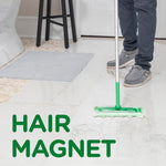 Person mopping a tiled floor with a Swiffer pad that has collected visible hair, captioned 'Hair Magnet'