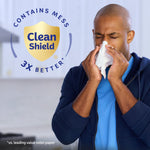 Person wiping their nose with a tissue next to a Clean Shield shield emblem stating contains mess 3X better