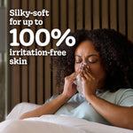 Person using a tissue in bed with headline text 'Silky-soft for up to 100% irritation-free skin'