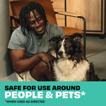 Smiling person crouched next to a seated black-and-white dog above copy proclaiming safe for use around people and pets
