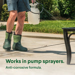 Person wearing green rubber boots holding a pump sprayer over a concrete driveway, text reads 'Works in pump sprayers'