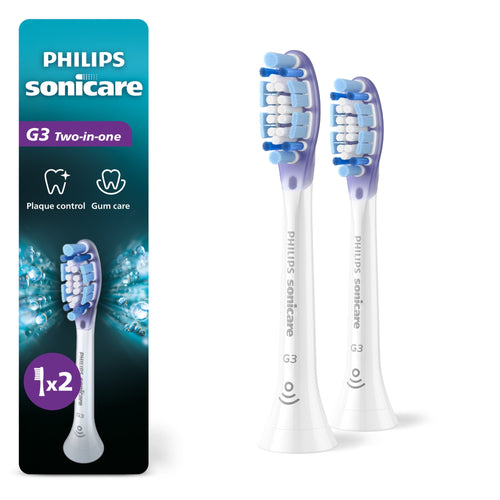 Two white Philips Sonicare G3 replacement brush heads shown next to branded packaging panel with product name and icons